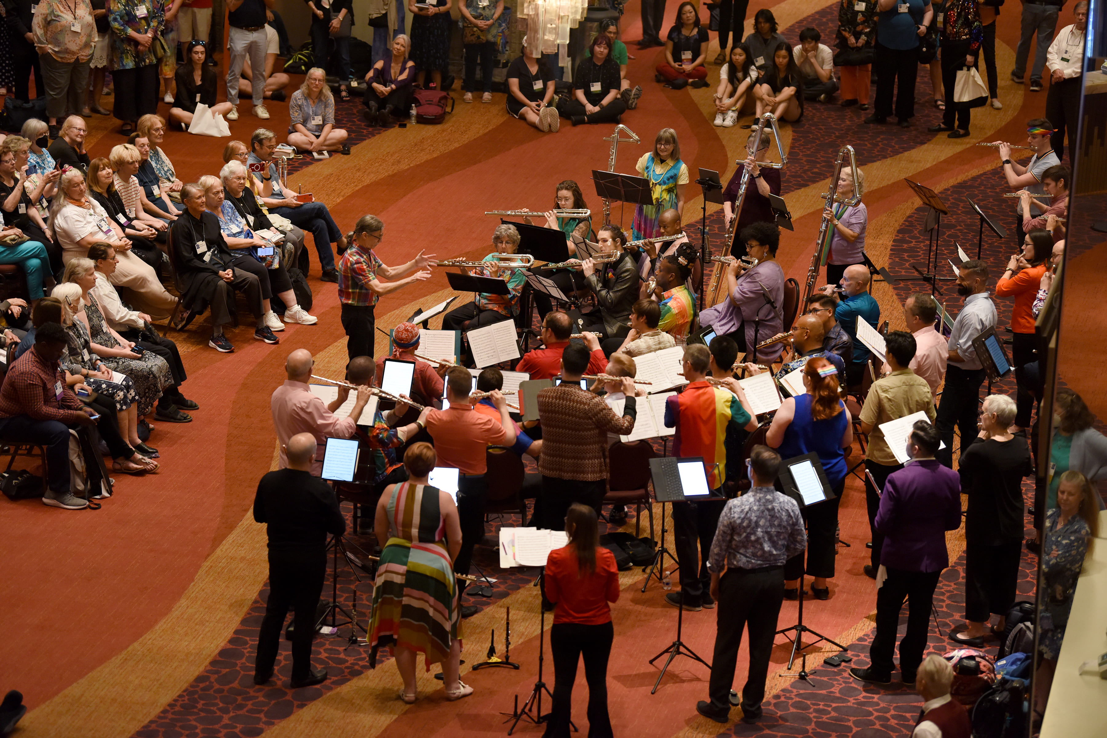 a flute choir plays in a crowded lobby